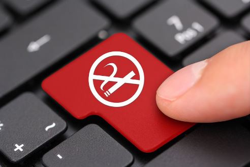 Red keyboard button with a no smoking sign Red keyboard button with a no smoking sign